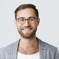 A man smiling and wearing spectacles