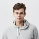 Man wearing earbuds and gray hoodie