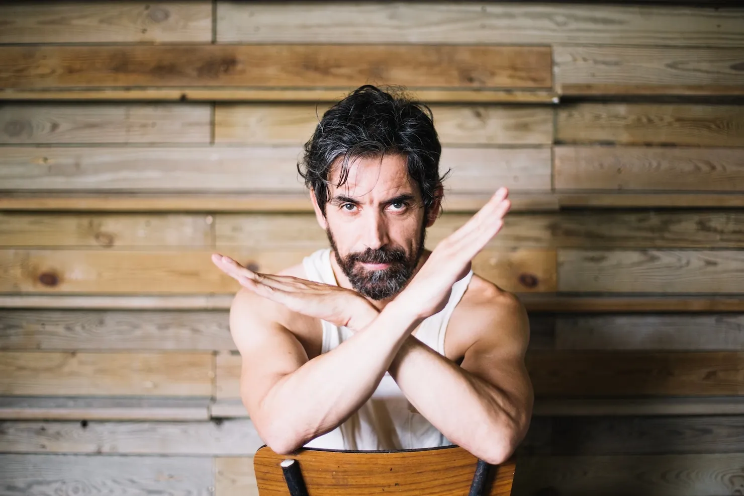 Man making crossed arm gesture representing mischief charges